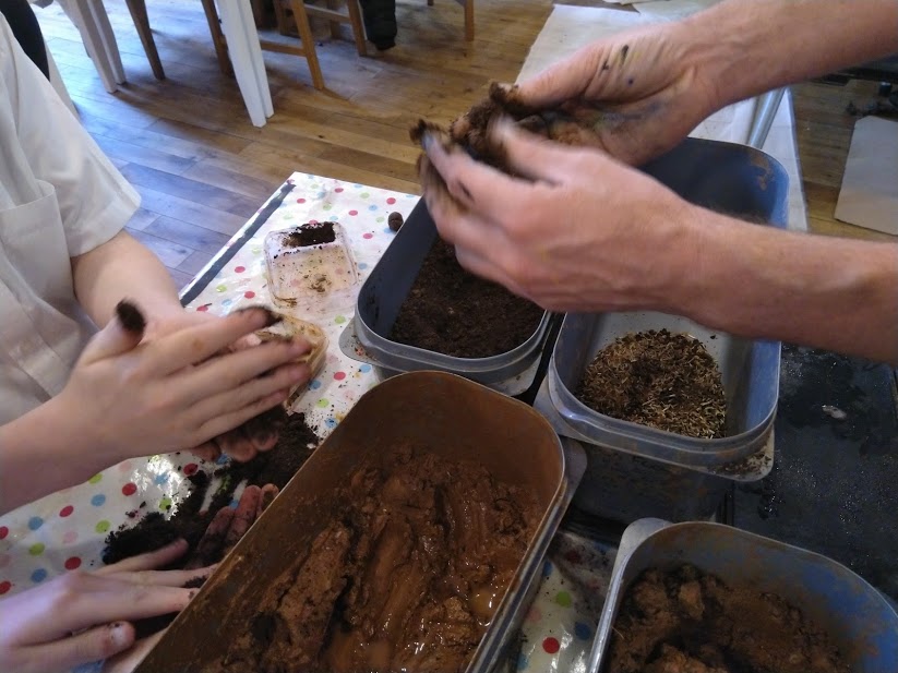 dirty hands rolling seed bombs